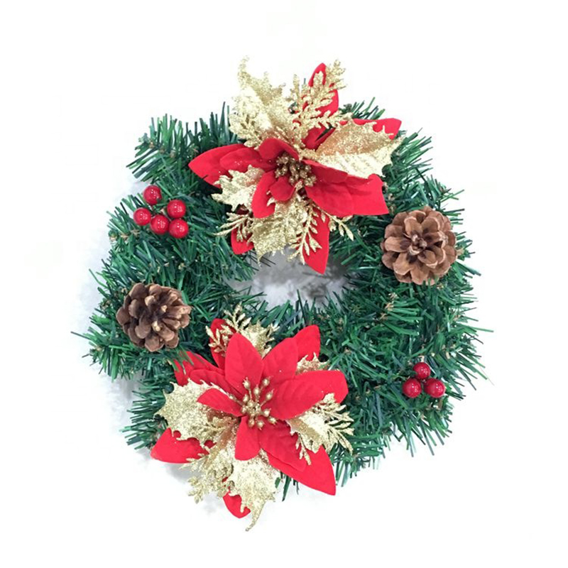 Christmas wreath with poinsettia, pinecones and red berries